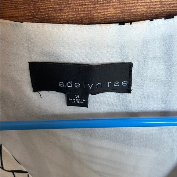 Adelyn Rae Black and Orange Patterned Romper - Picture 2 of 9